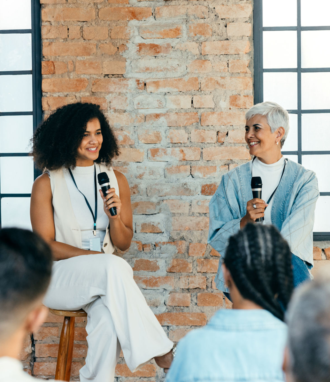 Two women speaking at a panel discussion.