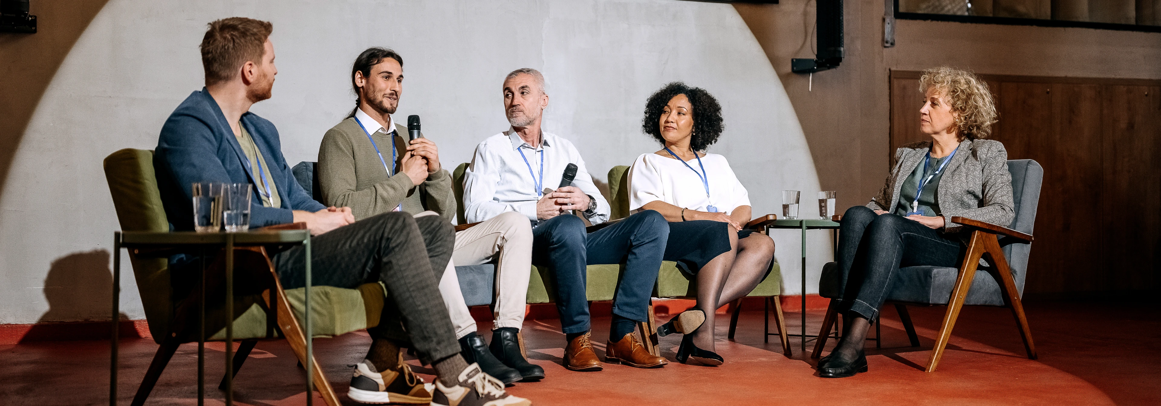 Panel discussion with five diverse participants speaking.